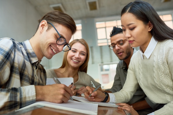 A mutli-ehnic group of students having fun in lecture hall