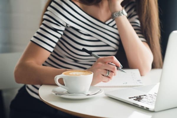 A lady writing a reference letter